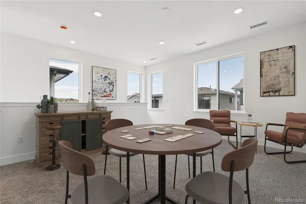 a large kitchen with kitchen island a dining table and chairs