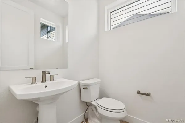 a bathroom with white cabinets and sink