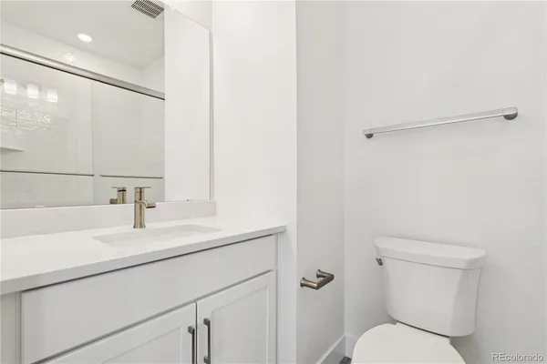 a bathroom with double sink and a mirror