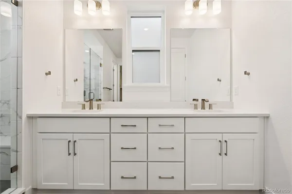 a bathroom with a granite countertop sink a toilet and a mirror