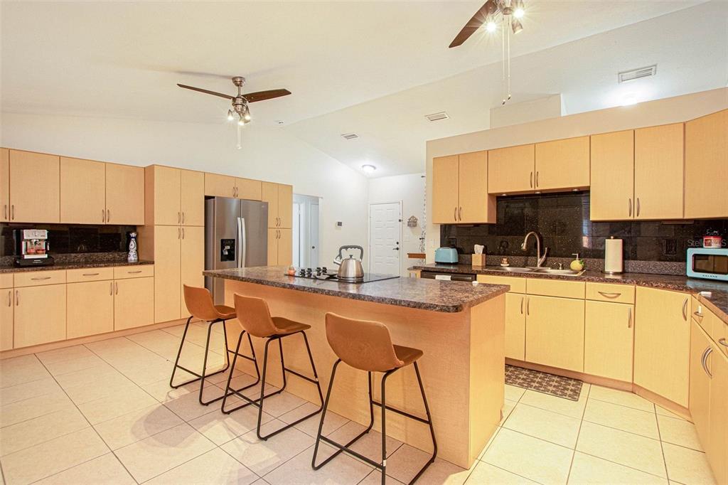 4105 Spring Way Circle Valrico, FL 33596 - Photo 12 of 34 a kitchen with stainless steel appliances granite countertop a stove a sink a microwave and a refrigerator