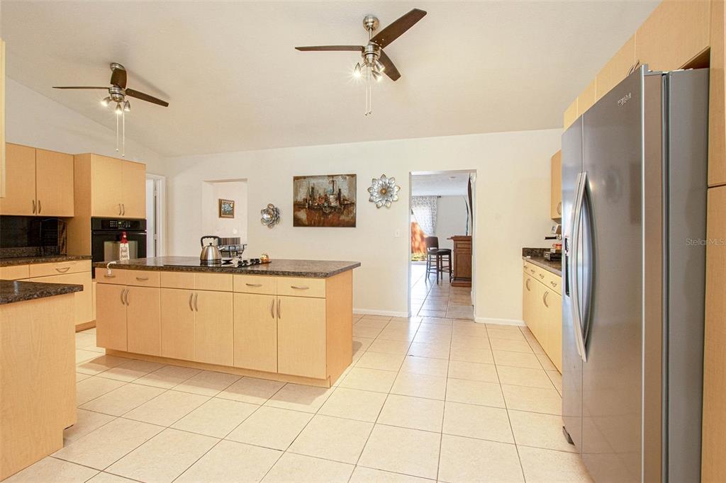 4105 Spring Way Circle Valrico, FL 33596 - Photo 13 of 34 a kitchen with stainless steel appliances granite countertop a refrigerator and a stove top oven
