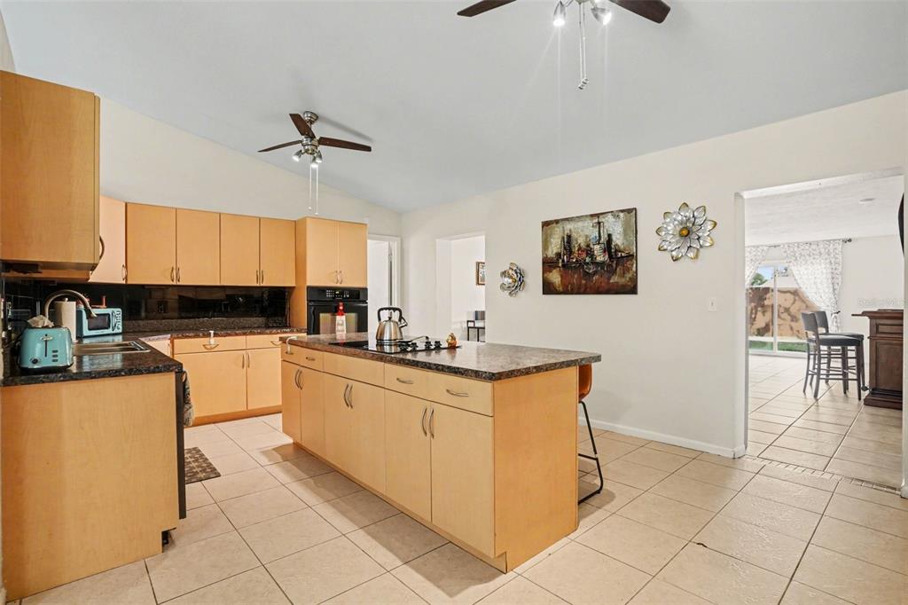 4105 Spring Way Circle Valrico, FL 33596 - Photo 14 of 34 a kitchen with stainless steel appliances granite countertop a refrigerator and a stove top oven