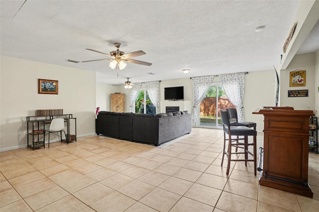 4105 Spring Way Circle Valrico, FL 33596 - Photo 20 of 34 a living room with furniture a dining table and a piano table