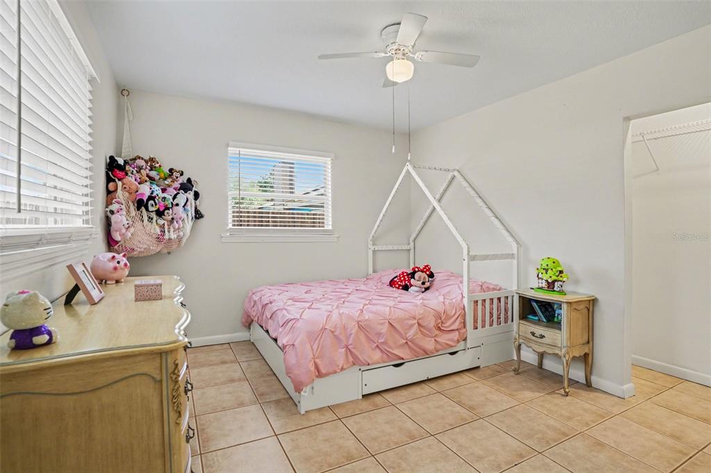 4105 Spring Way Circle Valrico, FL 33596 - Photo 25 of 34 a bedroom that has a bed and a table in it