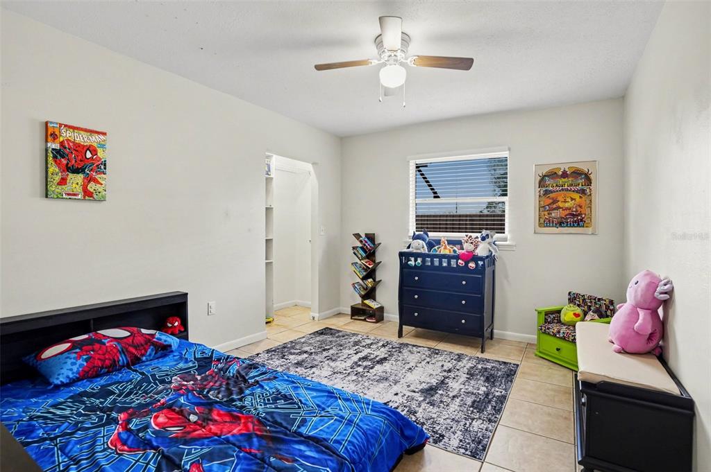 4105 Spring Way Circle Valrico, FL 33596 - Photo 27 of 34 a bedroom with a bed and wooden floor
