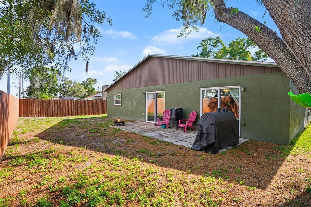 4105 Spring Way Circle Valrico, FL 33596 - Photo 34 of 34 a view of a backyard with a barbeque and wooden fence