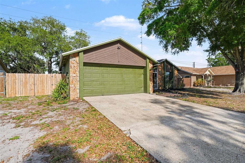 4105 Spring Way Circle Valrico, FL 33596 - Photo 4 of 34 a front view of a house with a yard and garage