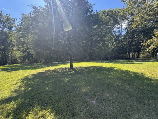 a view of outdoor space with swimming pool and green space