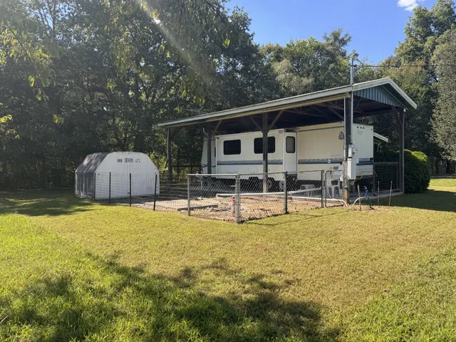 a view of a house with pool and chairs