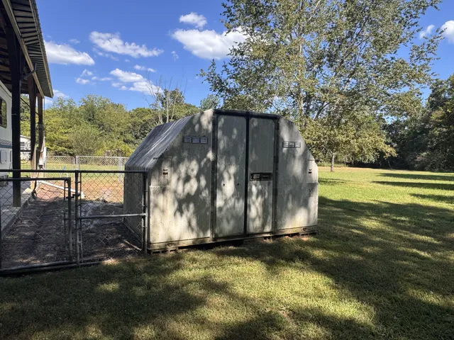 a view of dirt yard with a tree