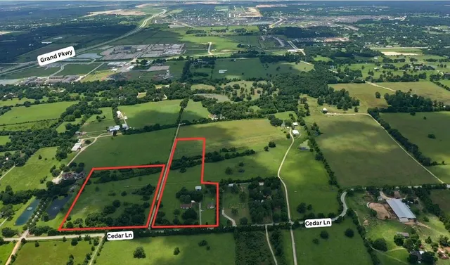 an aerial view of a residential houses with outdoor space and street view