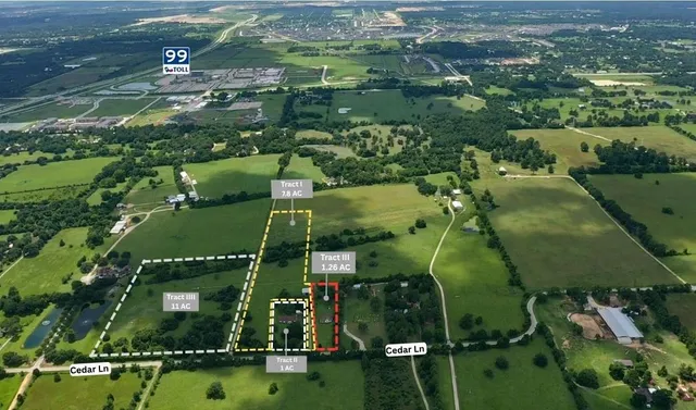 an aerial view of residential houses with outdoor space and river