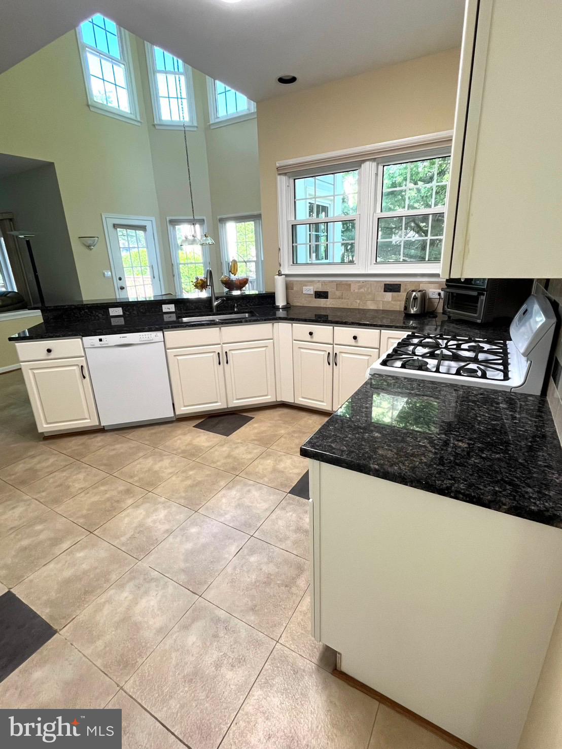 18717 Severn Road Gaithersburg, MD 20879 - Photo 15 of 44 a kitchen with stainless steel appliances granite countertop a stove a sink and a microwave
