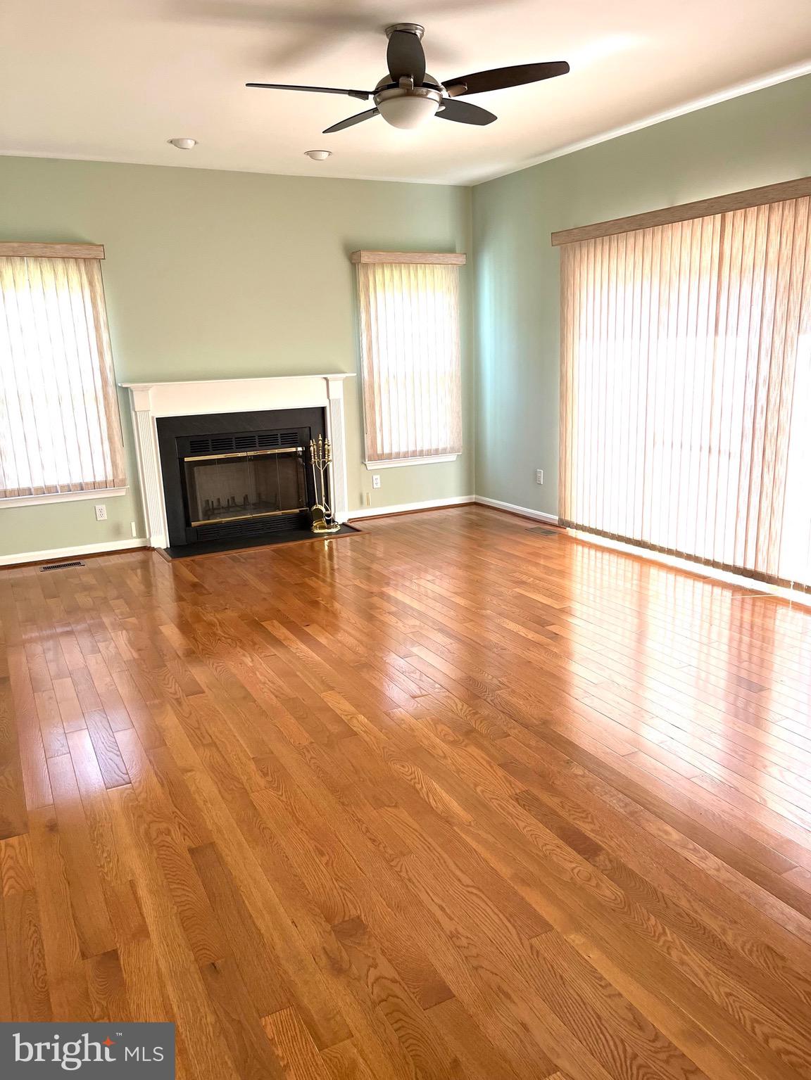 18717 Severn Road Gaithersburg, MD 20879 - Photo 19 of 44 an empty room with wooden floor fireplace and windows