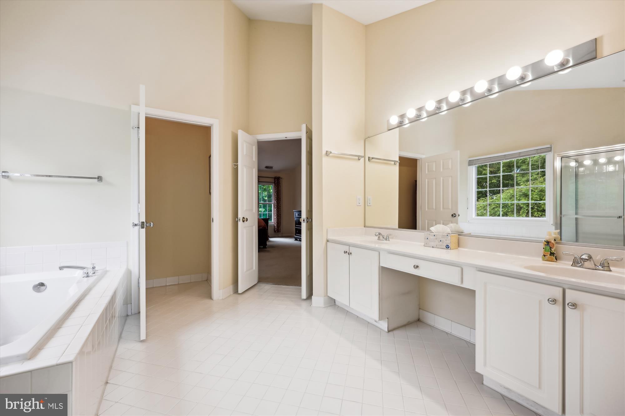 18717 Severn Road Gaithersburg, MD 20879 - Photo 31 of 44 a large bathroom with a large tub a sink shower and mirror