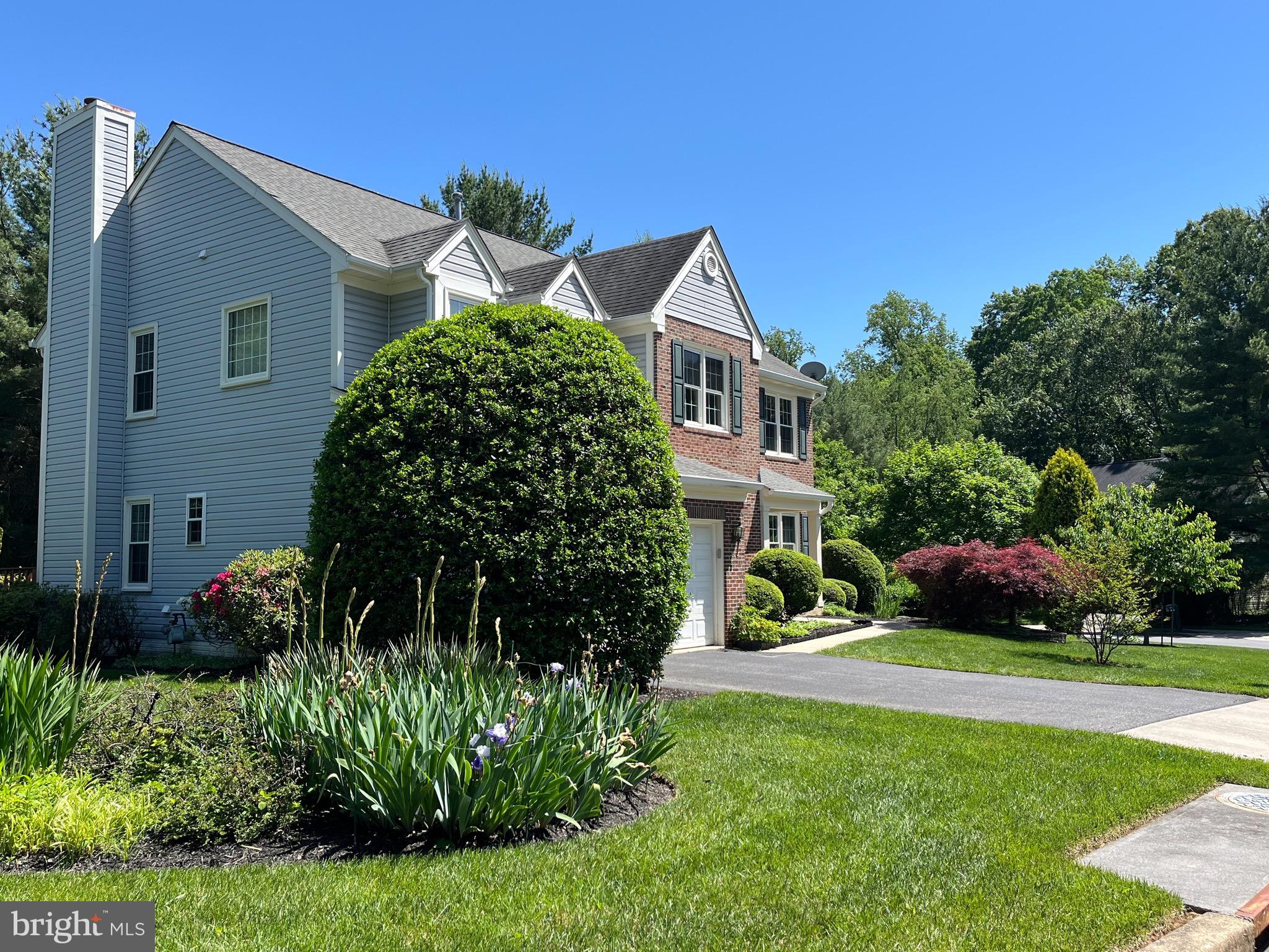 18717 Severn Road Gaithersburg, MD 20879 - Photo 4 of 44 a front view of a house with a garden and plants