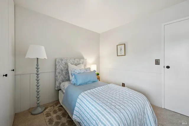 a bedroom with a bed and a lamp