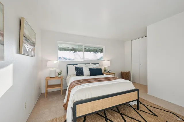 a bedroom with a bed and window