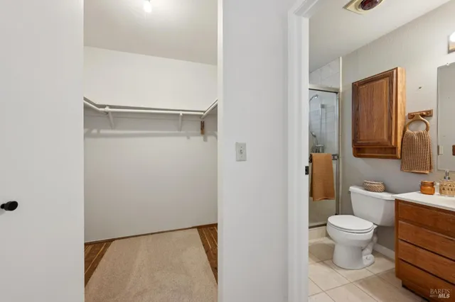 a bathroom with a toilet a sink and a mirror
