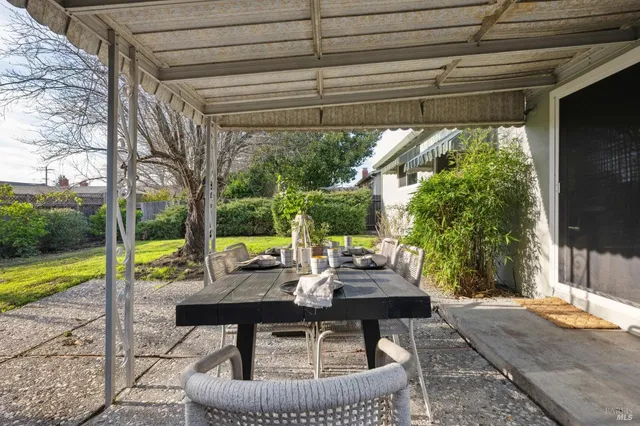 a view of backyard with swimming pool and outdoor seating