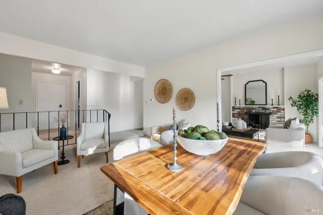 a living room with furniture potted plant and a fireplace