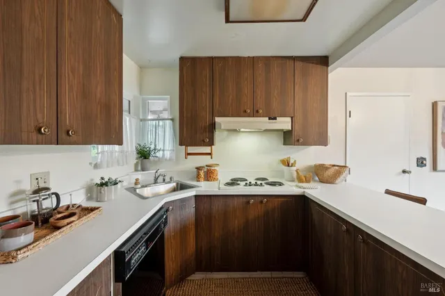 a kitchen with a sink cabinets and appliances