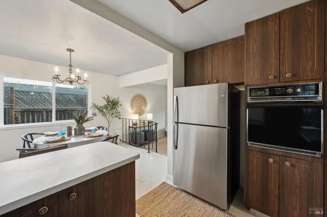 a kitchen with stainless steel appliances a refrigerator a stove a sink and a counter space