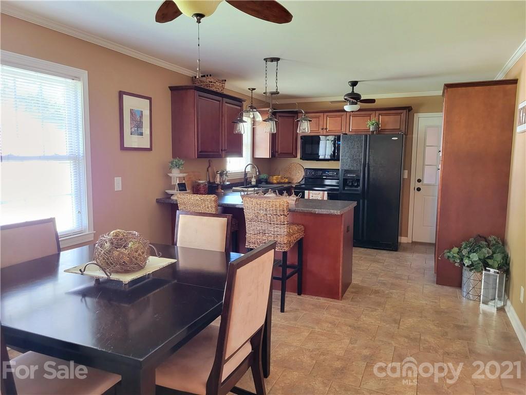 3411 Fallston Road Shelby, NC 28150 - Photo 11 of 39 a kitchen with a dining table and chairs