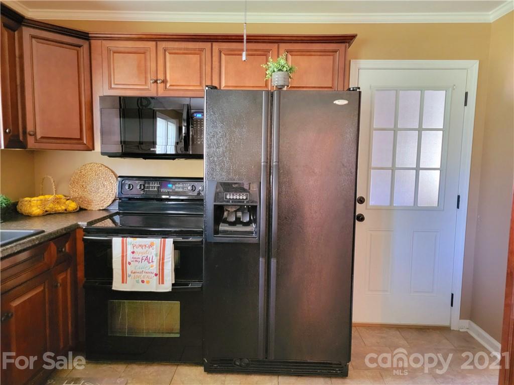 3411 Fallston Road Shelby, NC 28150 - Photo 13 of 39 a kitchen with stainless steel appliances granite countertop a refrigerator and a stove