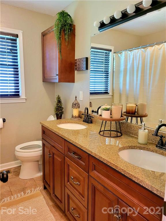 3411 Fallston Road Shelby, NC 28150 - Photo 16 of 39 a bathroom with a granite countertop sink and a toilet