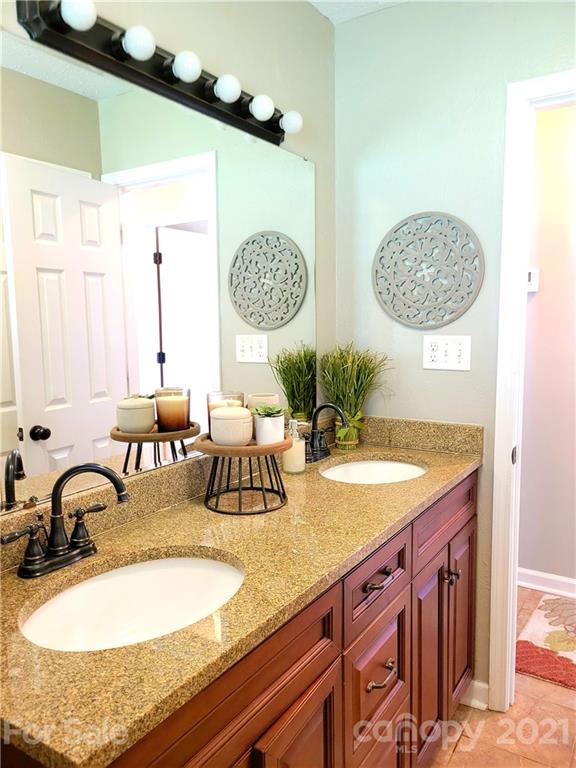 3411 Fallston Road Shelby, NC 28150 - Photo 18 of 39 a bathroom with a granite countertop sink and a mirror
