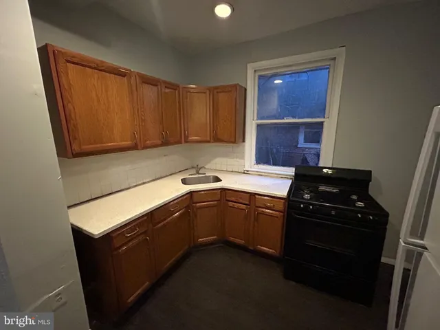 a kitchen with a refrigerator and a stove