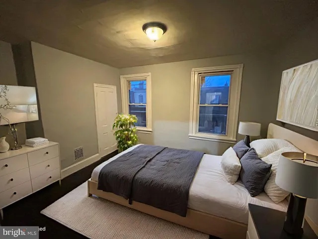 a bedroom with a bed and a night stand
