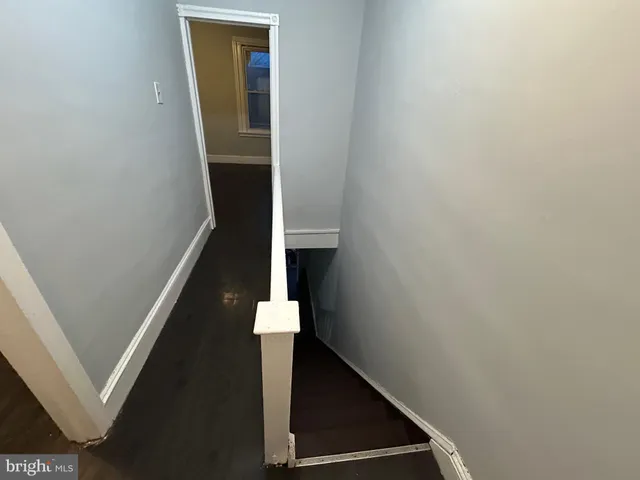 a view of a hallway with a door