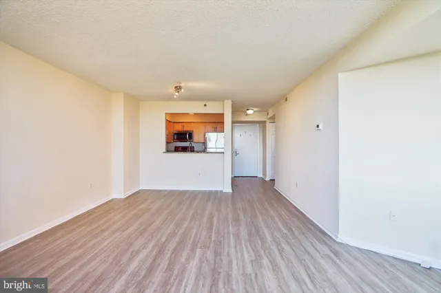 a view of a room with wooden floor