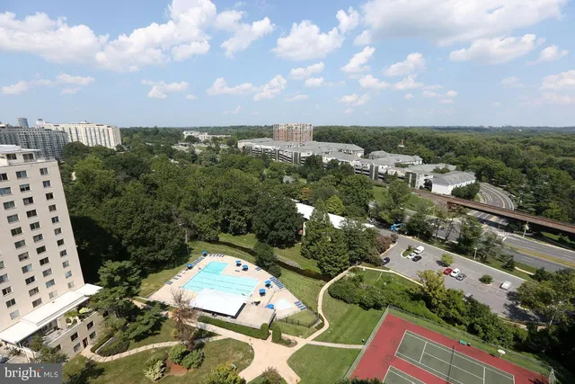an aerial view of multiple houses with yard