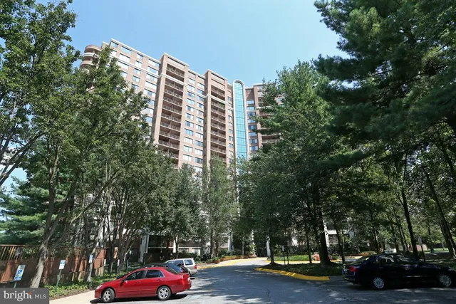 a front view of a building with trees