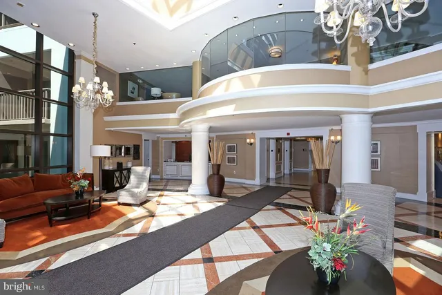 a living room with furniture a flat screen tv and a floor to ceiling window