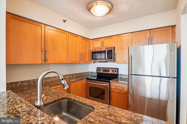 a kitchen with a refrigerator and a sink