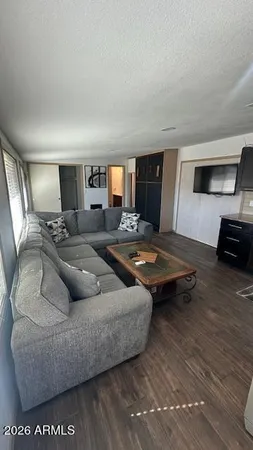 a living room with furniture and a wooden floor