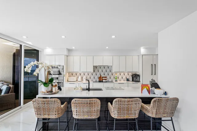 a view of a livingroom and a dining room with furniture