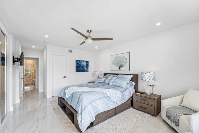 a bathroom with a double vanity sink mirror and shower