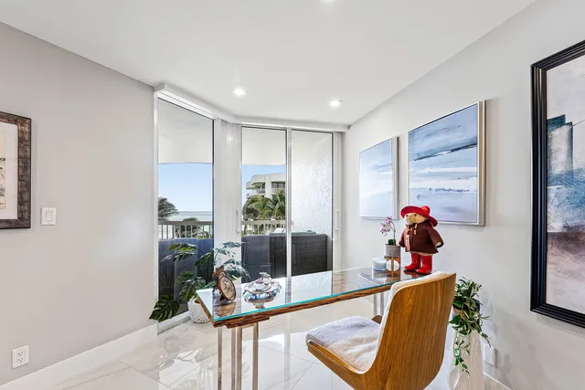 a spacious bedroom with a bed a couch and a flat screen tv