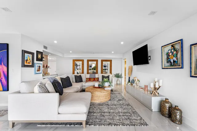 a kitchen with stainless steel appliances granite countertop a table chairs stove a refrigerator and a microwave