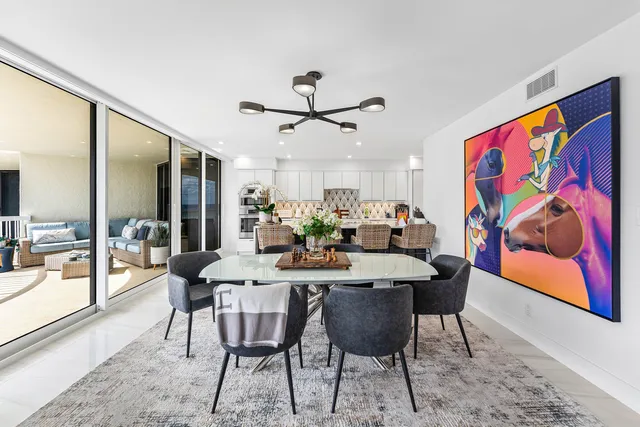 a large white kitchen with stainless steel appliances
