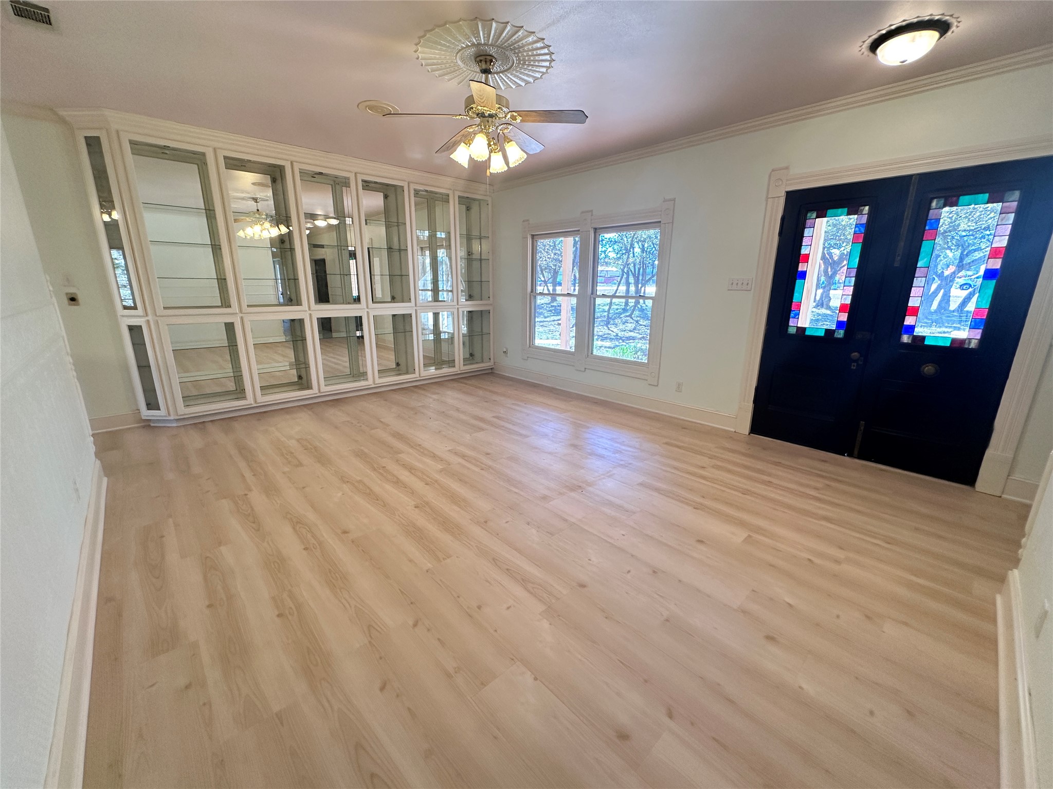 7130 Ranch 2338 Road Georgetown, TX 78633 - Photo 19 of 35 Gleaming light wood flooring and custom built-in cabinetry anchor this welcoming entrance space.