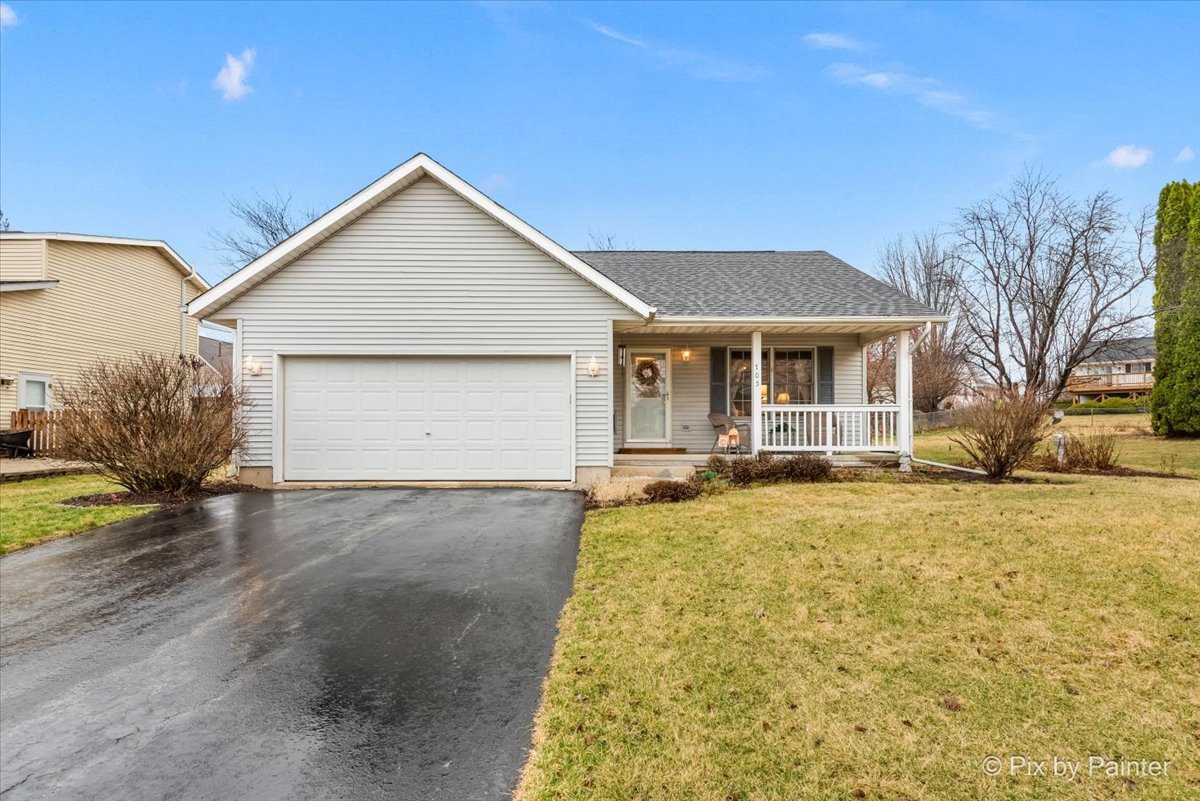 a view of a house with a yard and garage