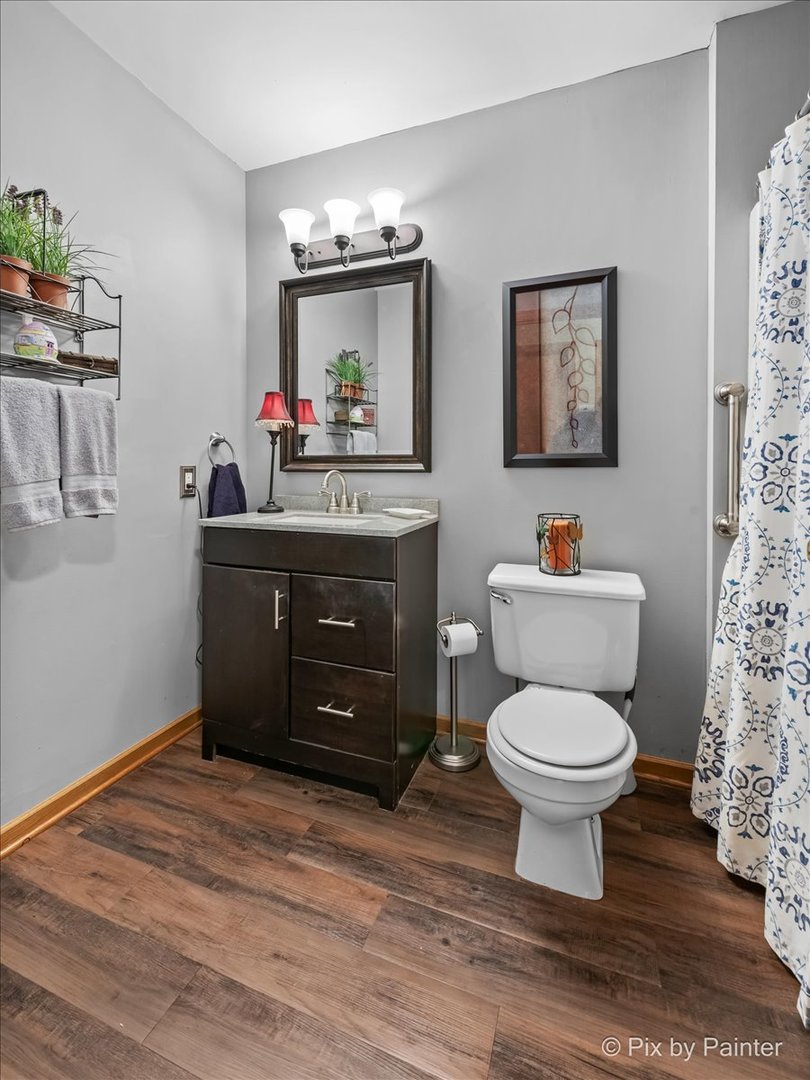 705 Cherry Tree Lane Genoa, IL 60135 - Photo 11 of 31 a room with a toilet a sink and a mirror