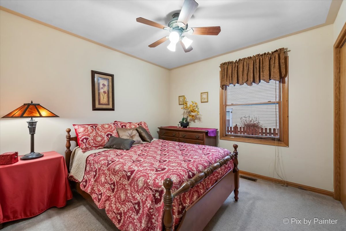 705 Cherry Tree Lane Genoa, IL 60135 - Photo 12 of 31 a bedroom with a bed and a painting on the wall